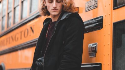 teen boy at school bus door
