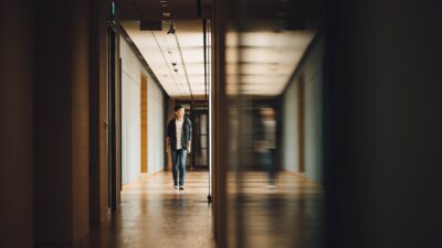boy by himself in a school hallway