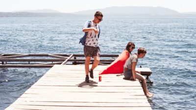 teens on pier over lake