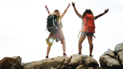 two girls enjoying outdoor program for youth empowerment on a mountain top