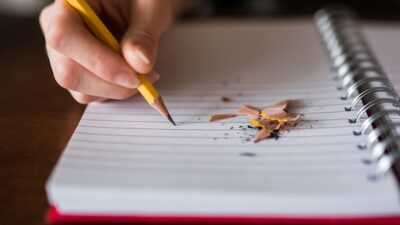 photo of sharpened pencil on notebook page with pencil shavngs