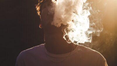 young man vaping in football jersey